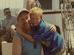 father and son on a boat